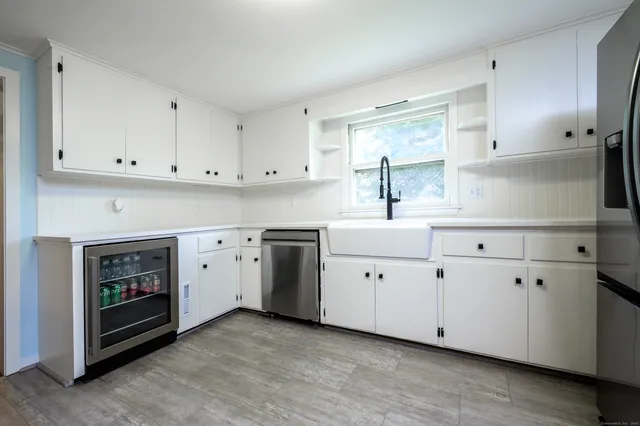 a kitchen with white cabinets and a sink