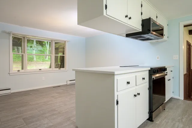 a kitchen with stainless steel appliances a stove and a refrigerator