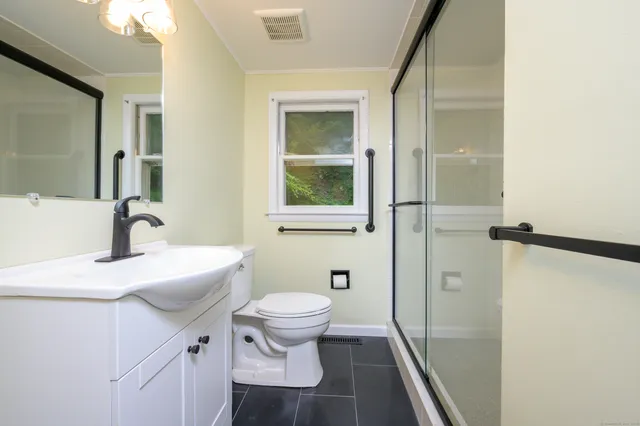 a bathroom with a sink toilet and shower