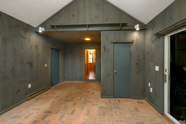 a view of hallway with a bathroom