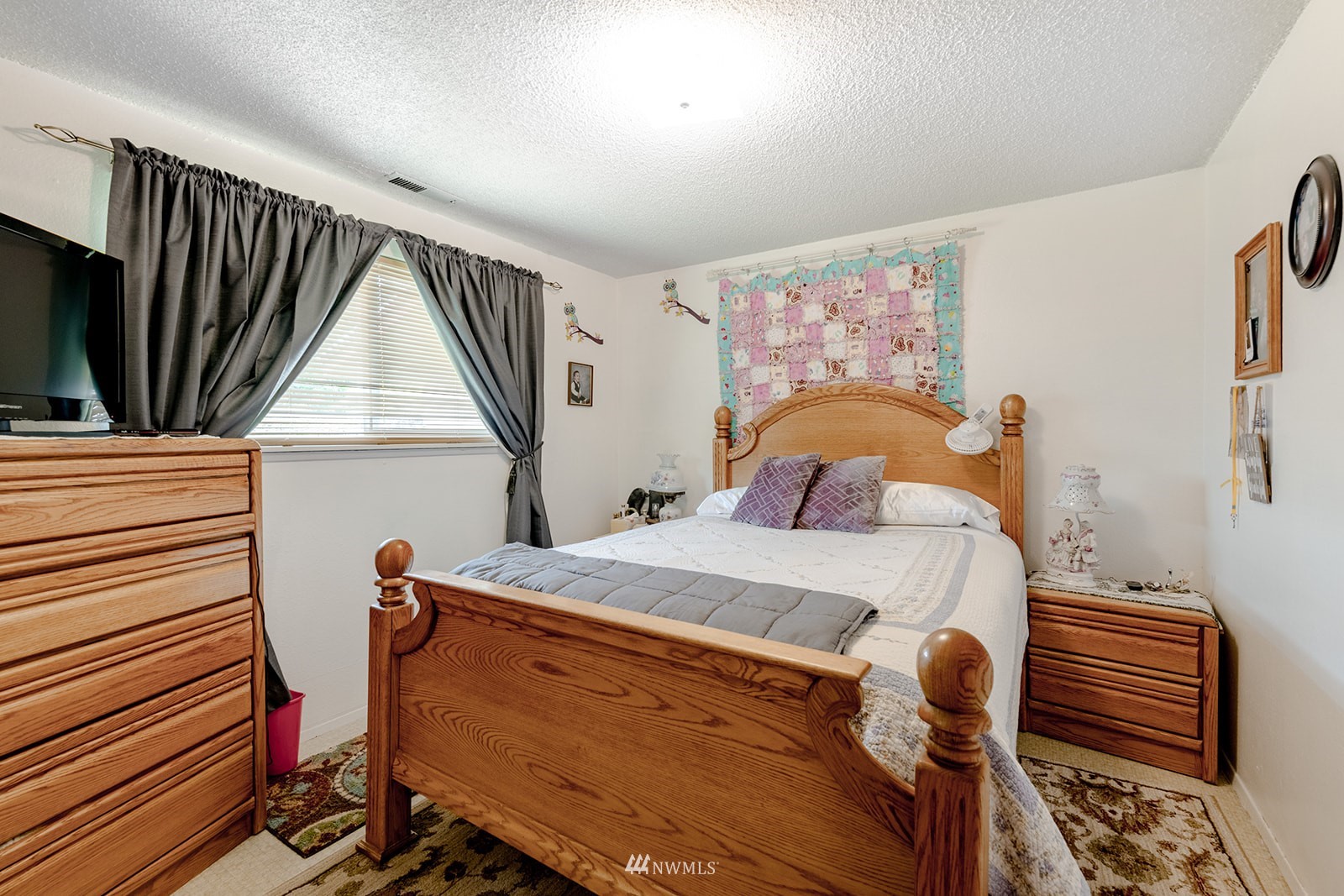 1209 Dundee Drive Cosmopolis, WA 98537 - Photo 21 of 36 a bedroom with a bed and a flat tv screen