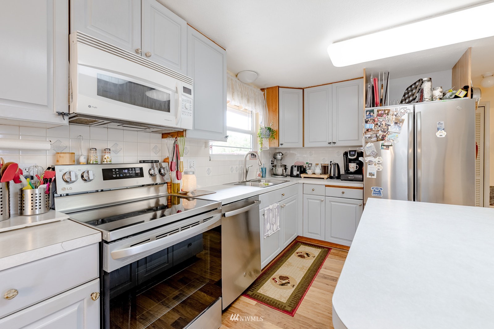 1209 Dundee Drive Cosmopolis, WA 98537 - Photo 23 of 36 a kitchen with a refrigerator and a stove top oven