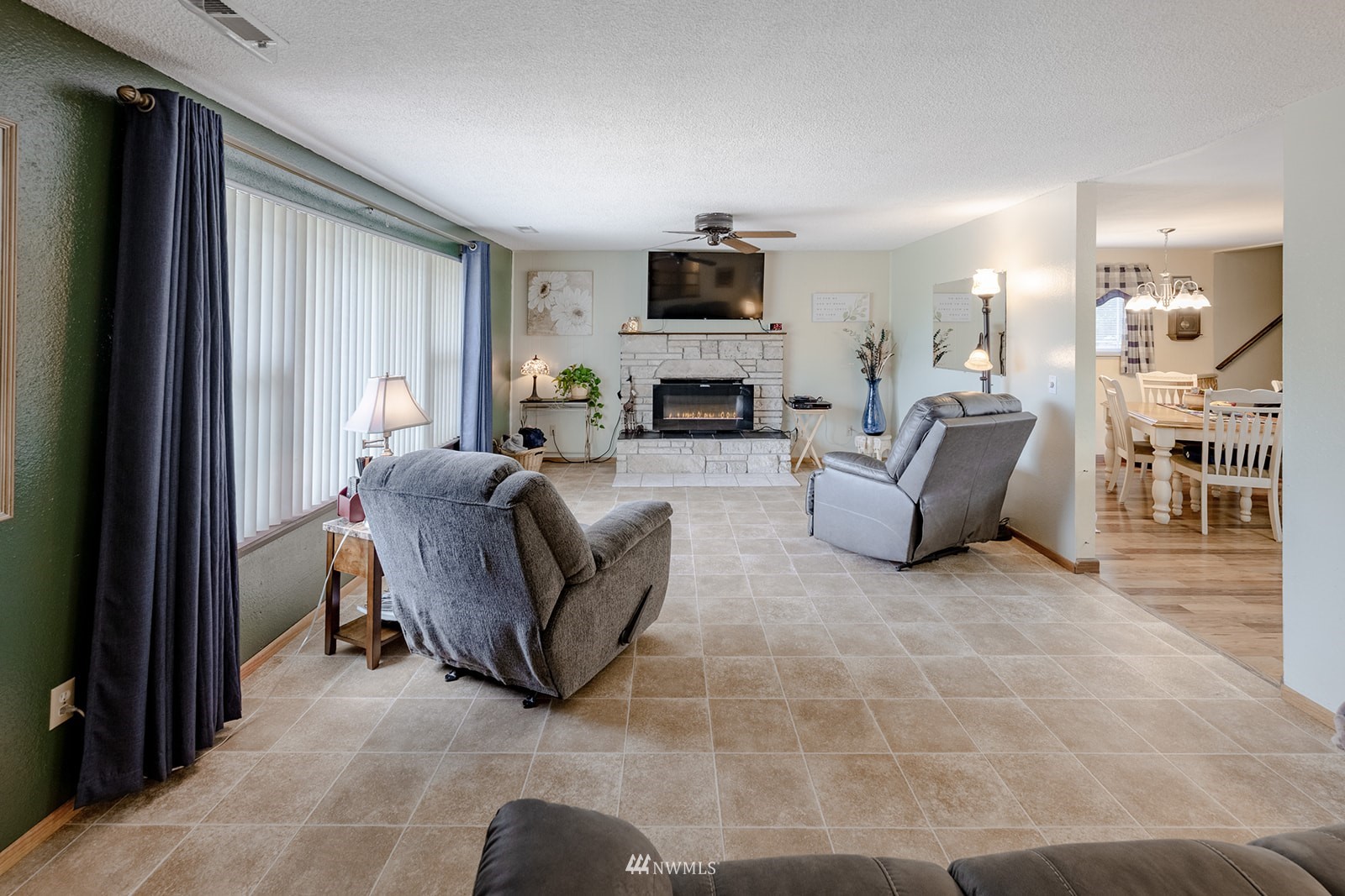 1209 Dundee Drive Cosmopolis, WA 98537 - Photo 34 of 36 a living room with furniture a fireplace and a flat screen tv