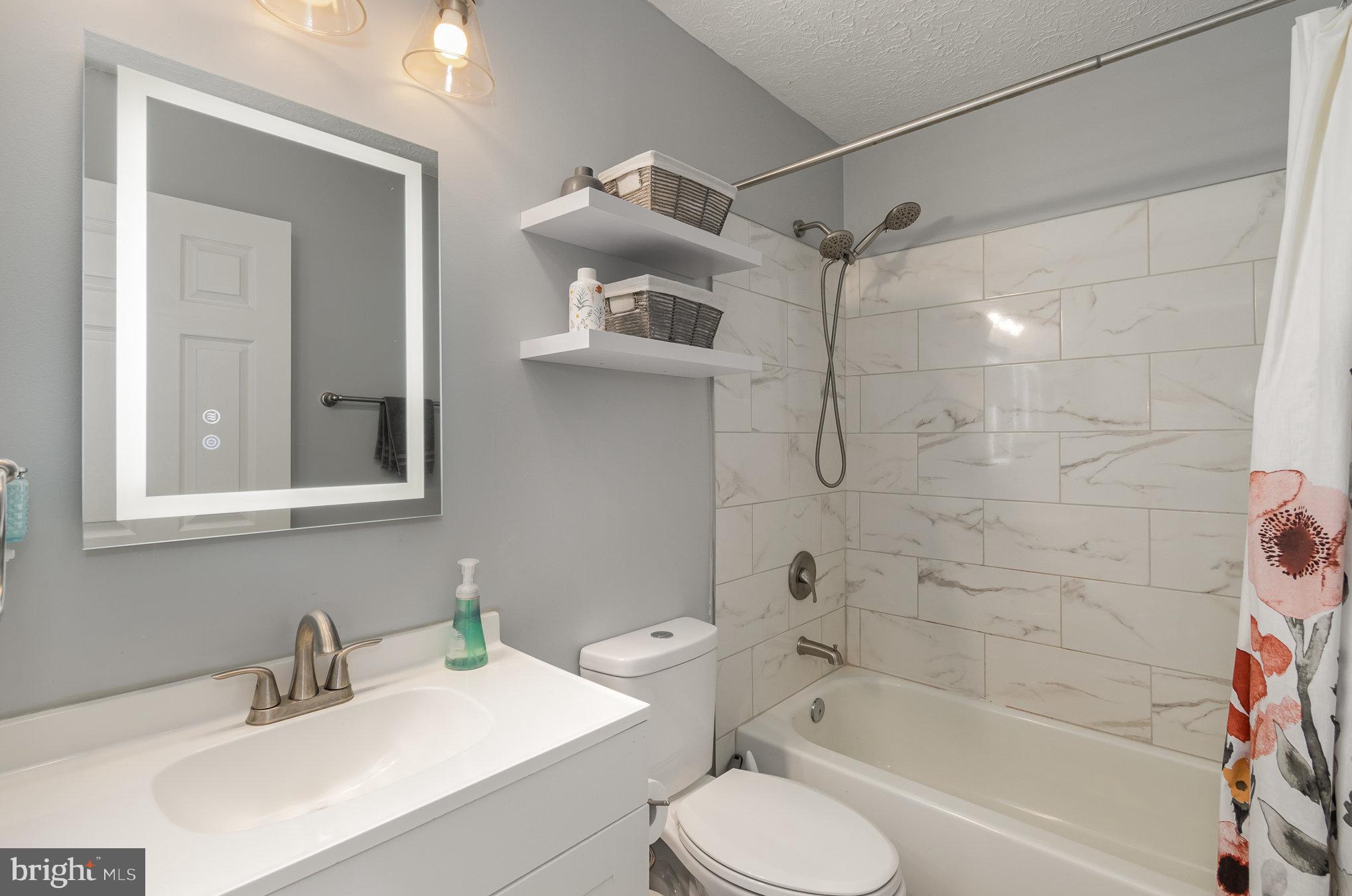 2114 Kyle Green Road Abingdon, MD 21009 - Photo 12 of 27 a bathroom with a bathtub shower sink vanity and toilet