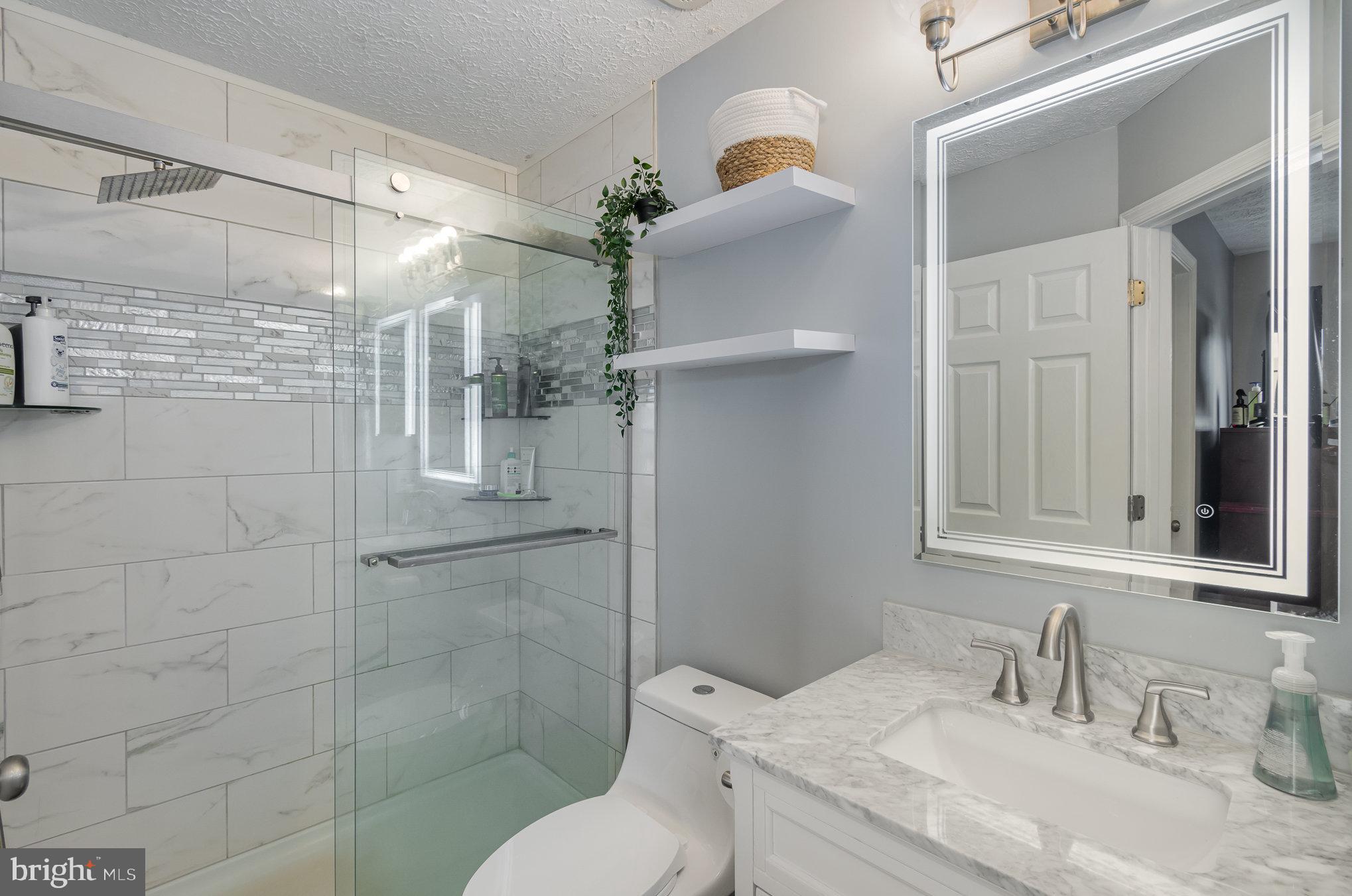 2114 Kyle Green Road Abingdon, MD 21009 - Photo 19 of 27 a bathroom with a granite countertop sink toilet and shower