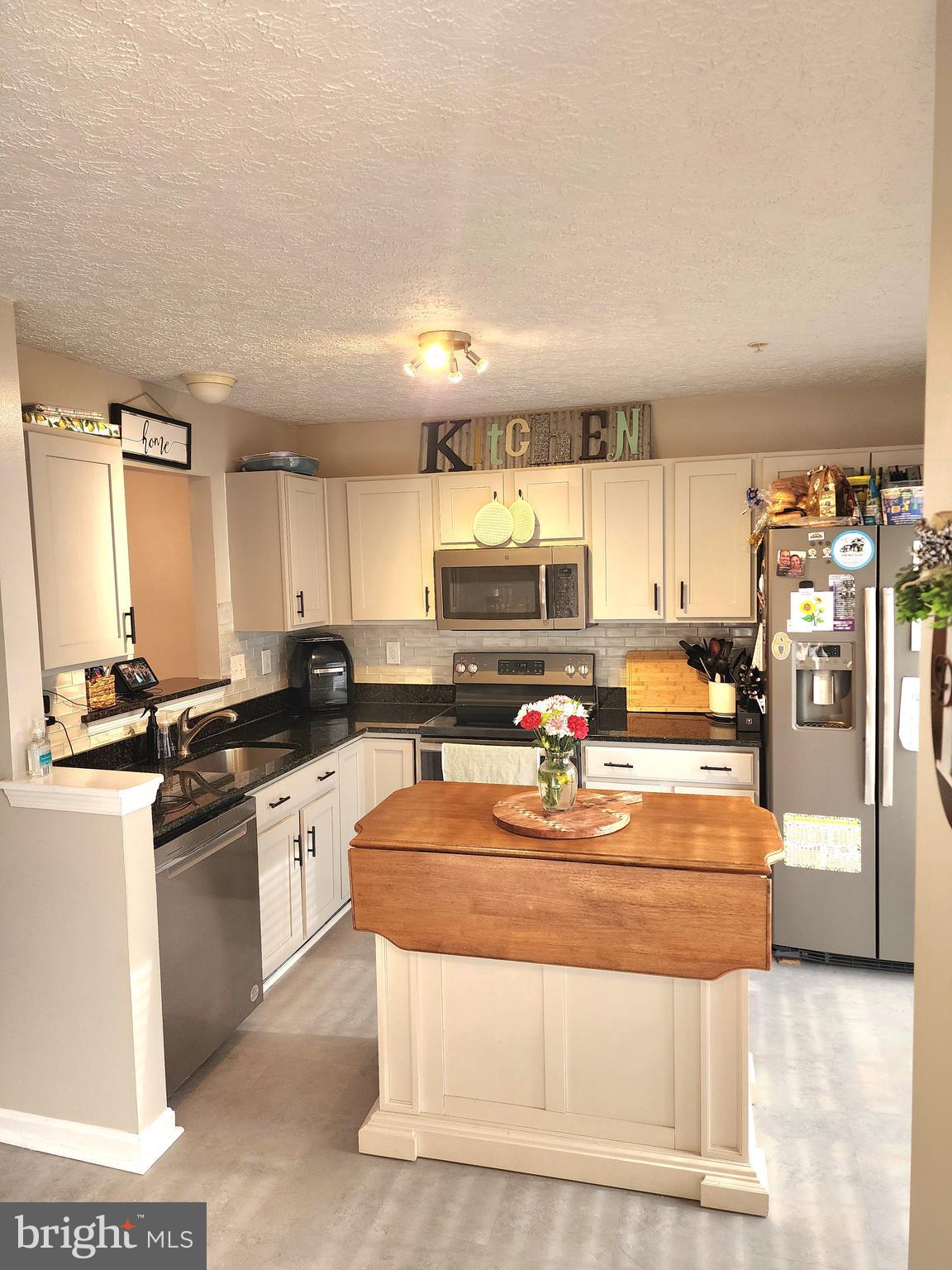 2114 Kyle Green Road Abingdon, MD 21009 - Photo 5 of 27 a kitchen with stainless steel appliances granite countertop a sink stove and refrigerator