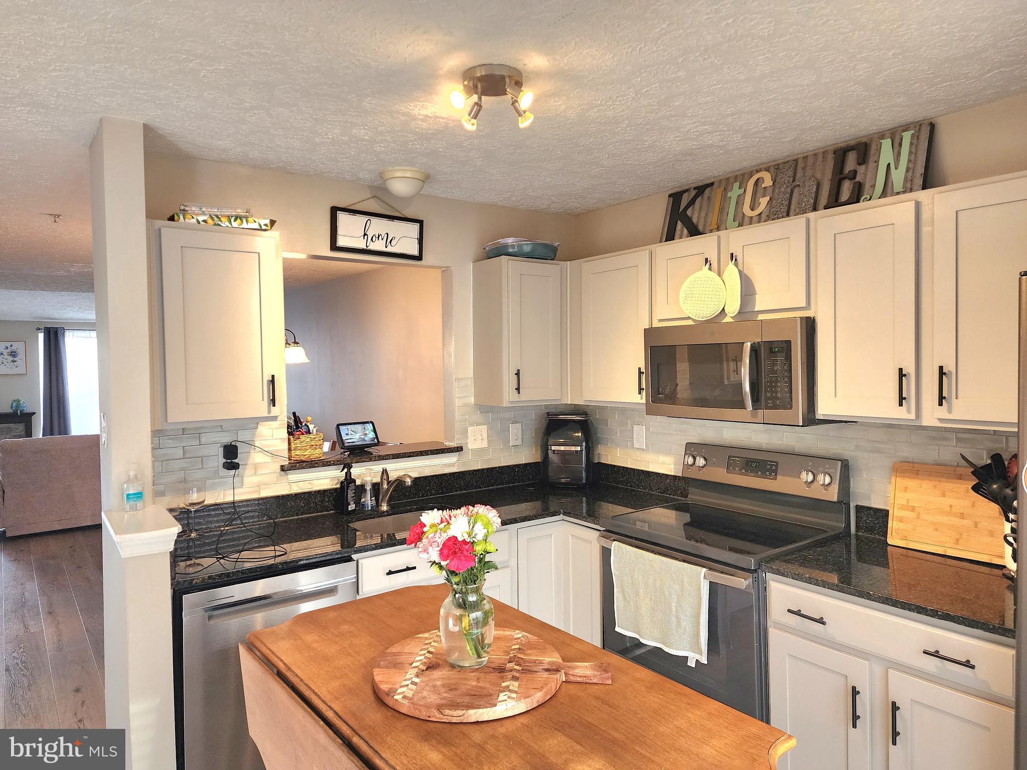 2114 Kyle Green Road Abingdon, MD 21009 - Photo 6 of 27 a kitchen with a stove a sink and a microwave