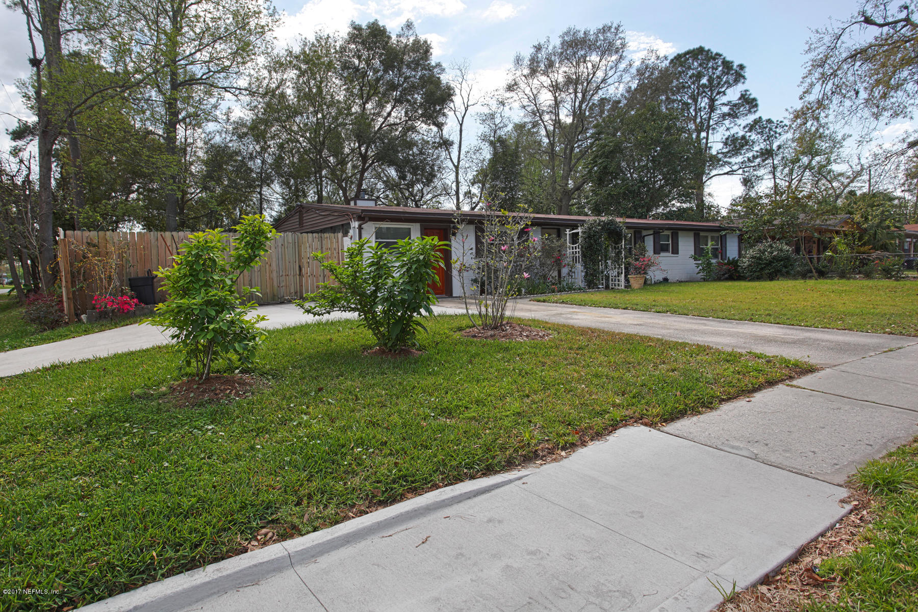 4956 Spring Glen Road Jacksonville, FL 32207 - Photo 2 of 23 a view of a backyard with large trees and plants
