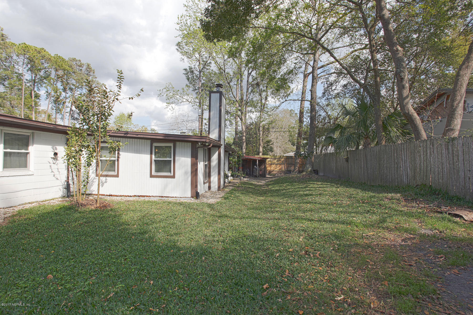 4956 Spring Glen Road Jacksonville, FL 32207 - Photo 23 of 23 a backyard of a house with table and chairs