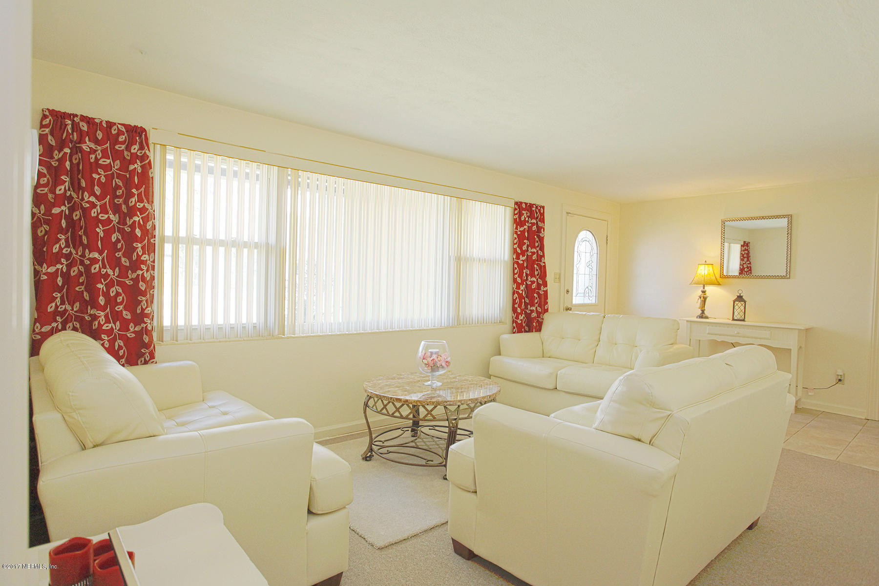 4956 Spring Glen Road Jacksonville, FL 32207 - Photo 4 of 23 a living room with furniture and a large window