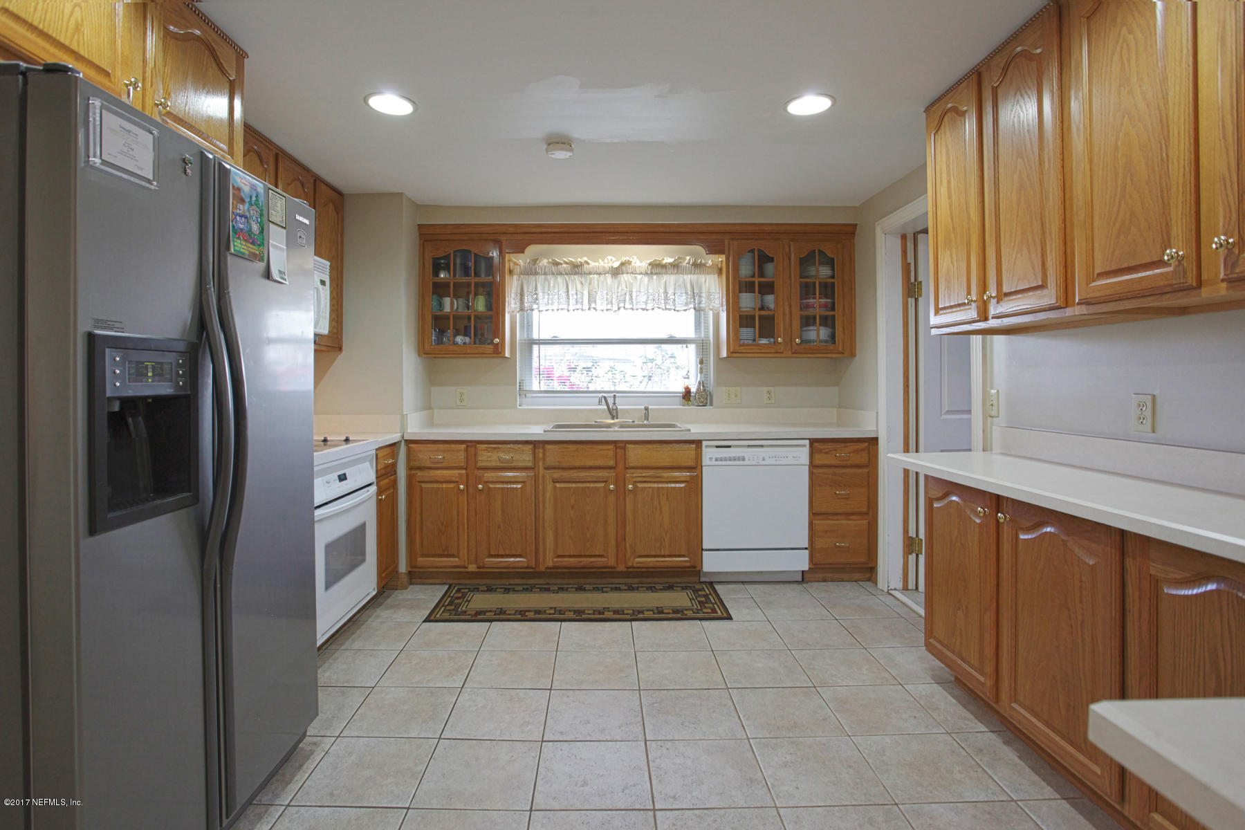 4956 Spring Glen Road Jacksonville, FL 32207 - Photo 5 of 23 a kitchen with stainless steel appliances granite countertop a refrigerator and a sink