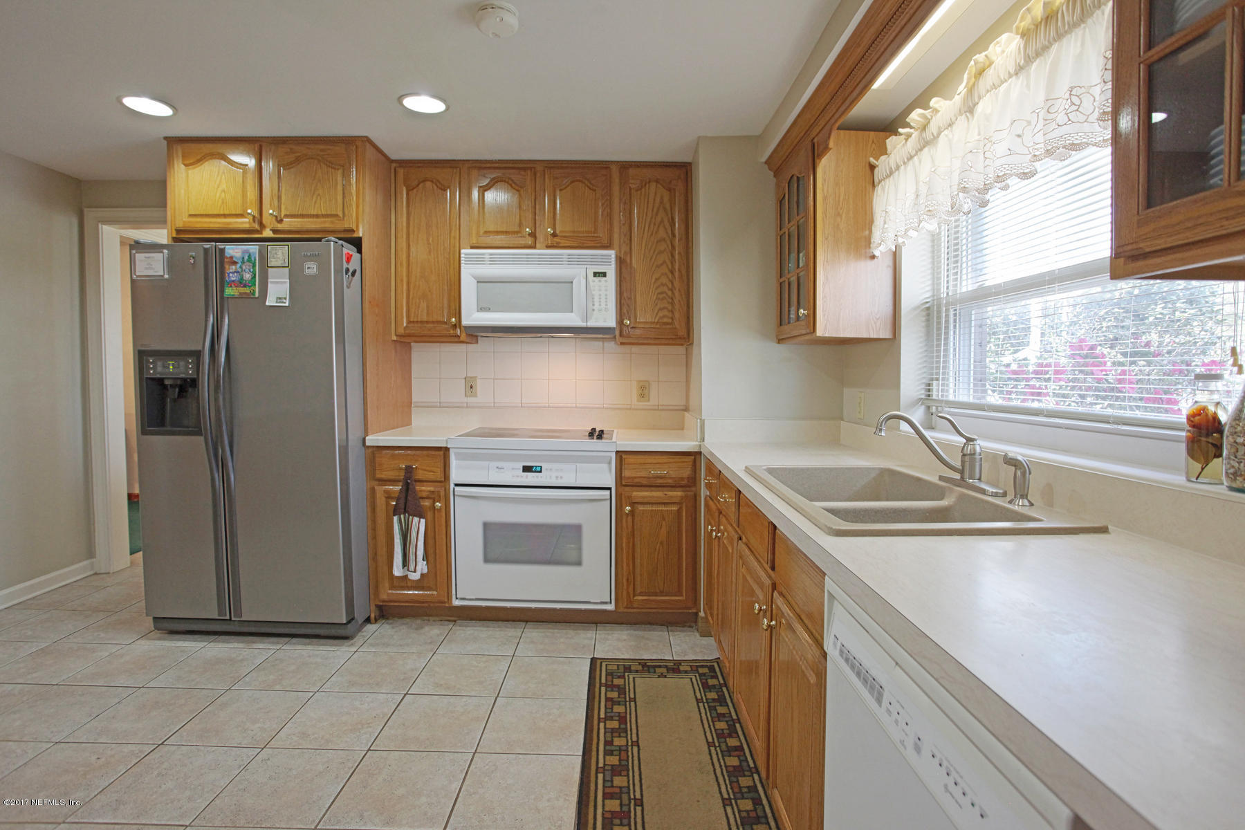 4956 Spring Glen Road Jacksonville, FL 32207 - Photo 7 of 23 a kitchen with stainless steel appliances granite countertop a sink stove and refrigerator