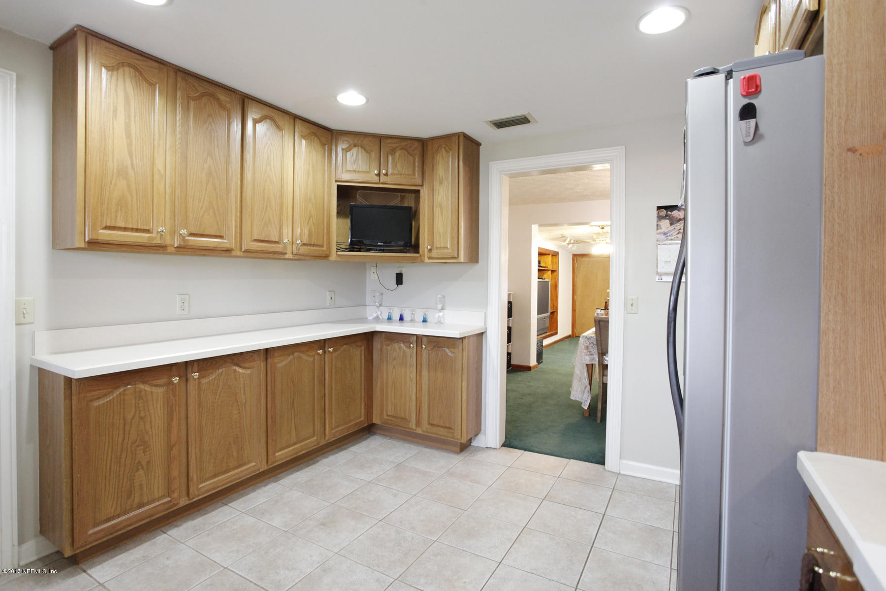 4956 Spring Glen Road Jacksonville, FL 32207 - Photo 8 of 23 a kitchen with a refrigerator sink and microwave