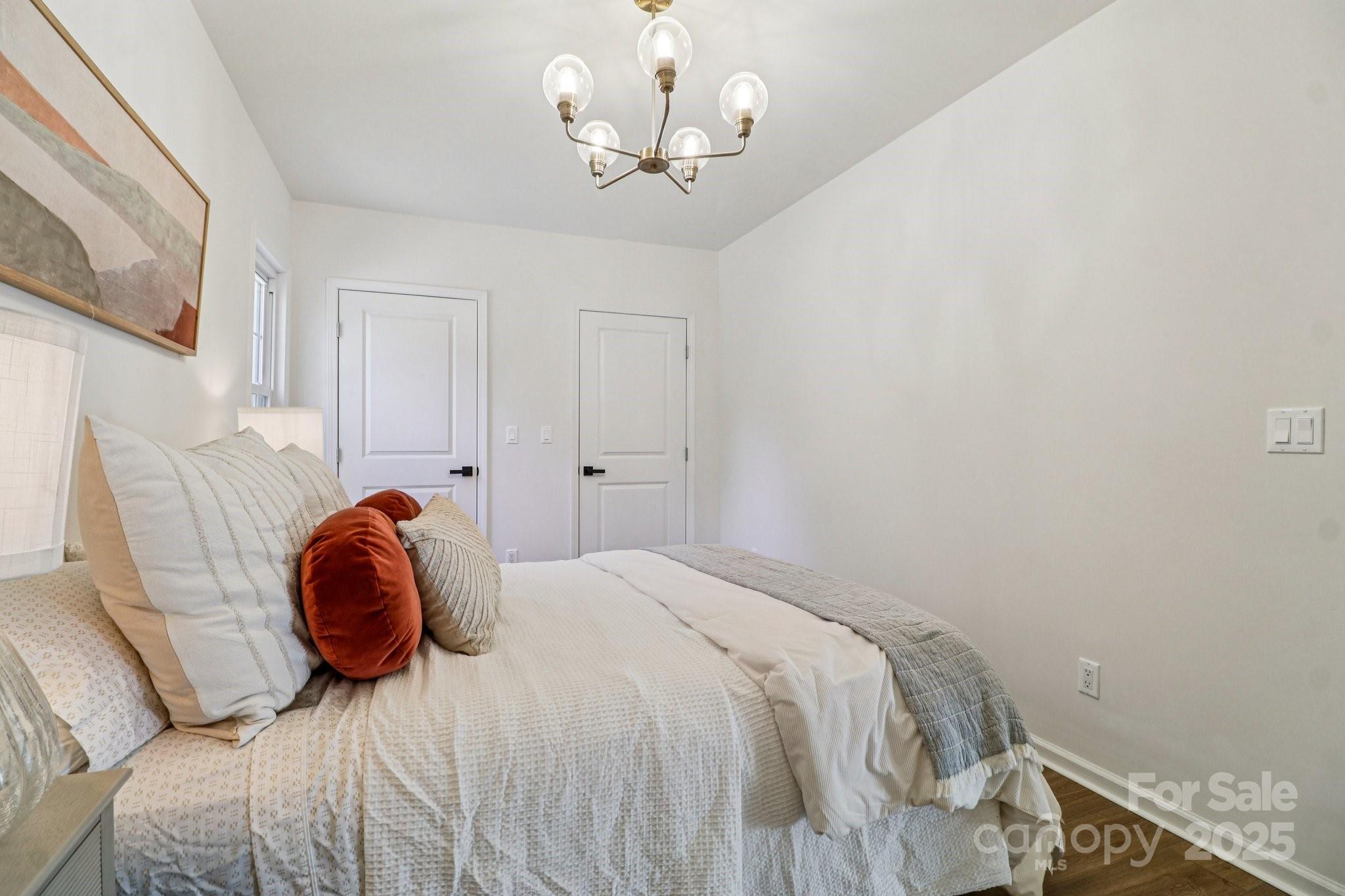 4409 Pleasant Road Lancaster, SC 29720 - Photo 17 of 34 a bedroom with a bed and a chandelier
