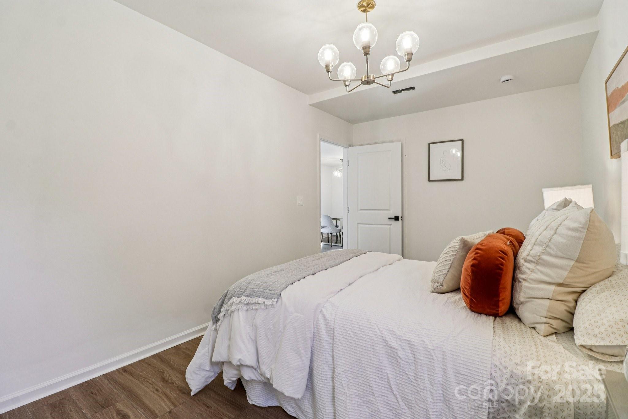 4409 Pleasant Road Lancaster, SC 29720 - Photo 18 of 34 a bedroom with a bed and wooden floor