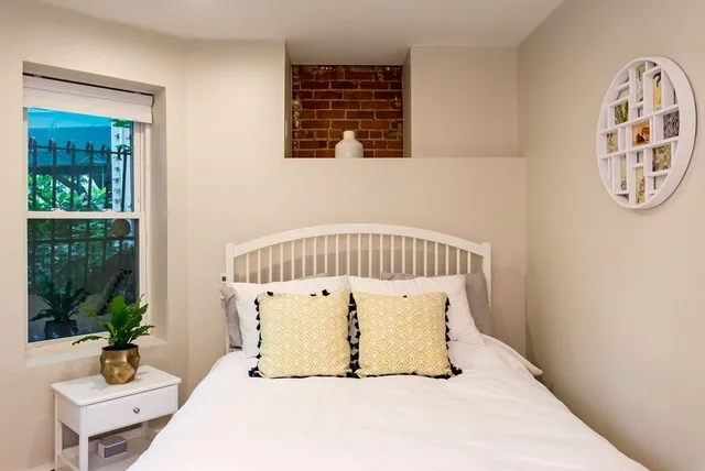 a view of a bedroom with a bed and glass windows