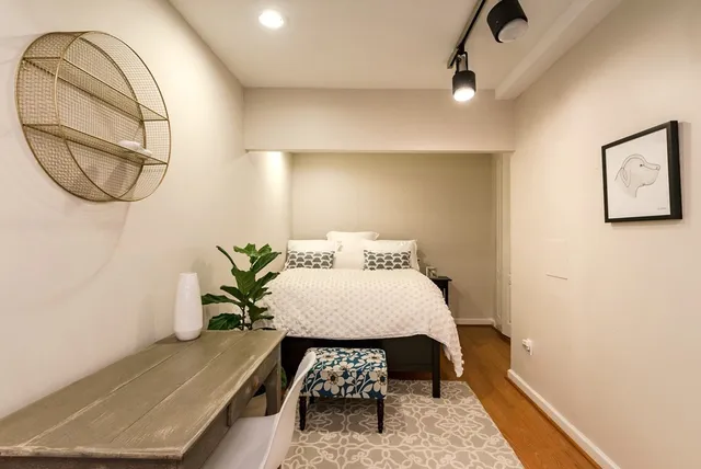 a view of a hallway with furniture and chandelier