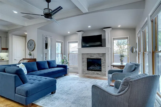 a living room with furniture a fireplace and a flat screen tv