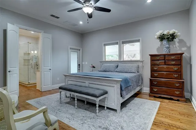 a spacious bedroom with a bed and a chandelier
