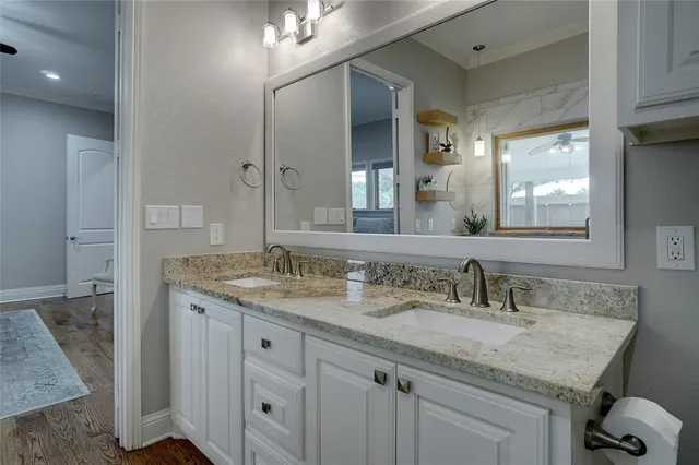 a bathroom with a granite countertop sink and a mirror