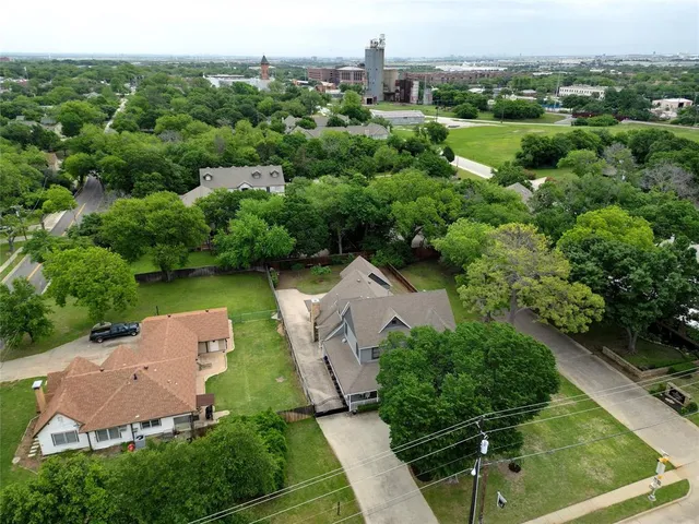 an aerial view of a house with yard