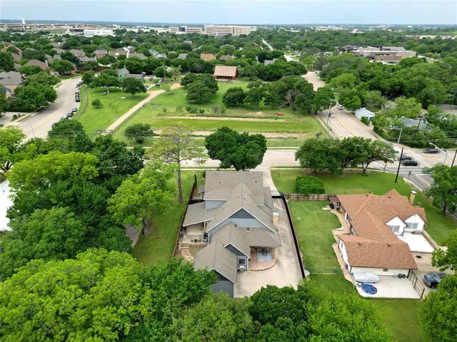 an aerial view of a house with a yard