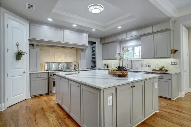 a kitchen with stainless steel appliances granite countertop a sink and cabinets