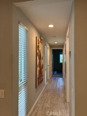 a view of hallway with wooden floor and stairs