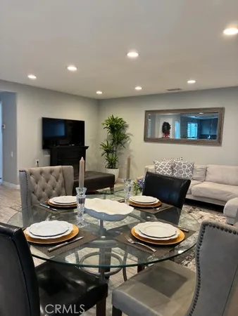 a living room with furniture and kitchen view