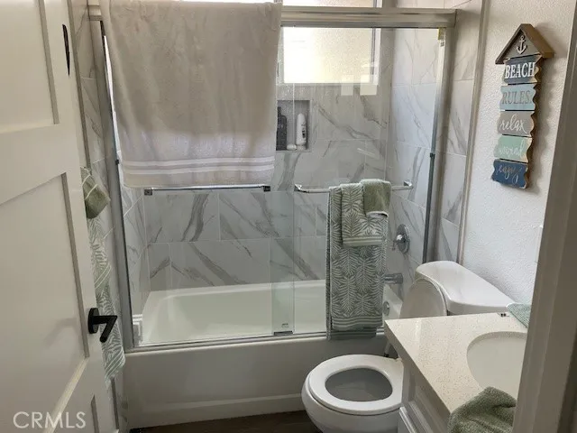 a white toilet sitting next to a bath tub