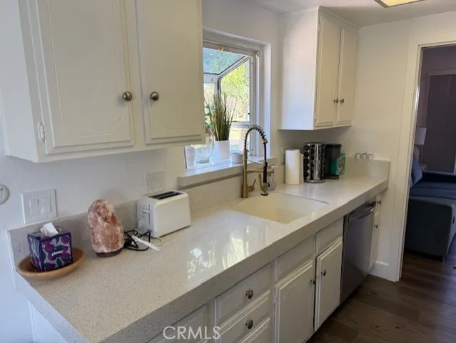 a kitchen with sink and cabinets
