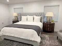 a bedroom with a bed and a night stand