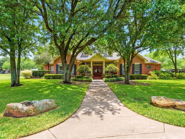 a front view of a house with a yard