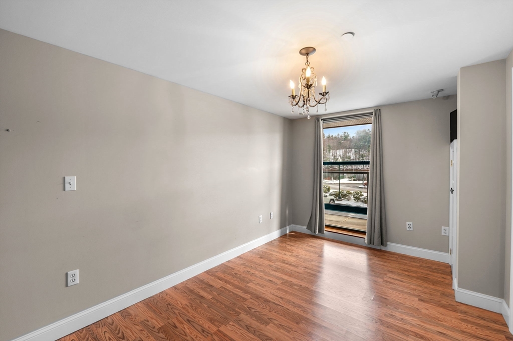 60 Merrimac Street, Unit 604 Amesbury, MA 01913 - Photo 18 of 42 wooden floor in an empty room with a window