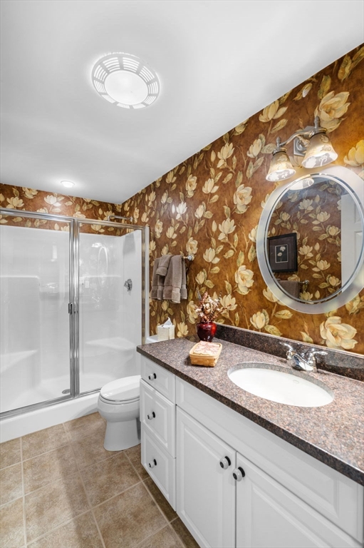 60 Merrimac Street, Unit 604 Amesbury, MA 01913 - Photo 21 of 42 a bathroom with a granite countertop sink and a mirror
