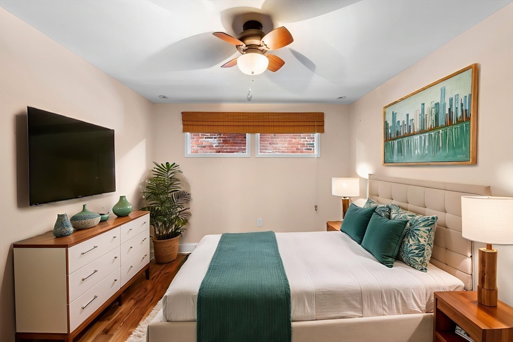 60 Merrimac Street, Unit 604 Amesbury, MA 01913 - Photo 22 of 42 a bedroom with a bed and a flat screen tv