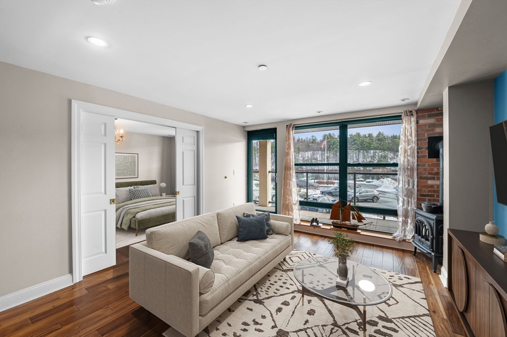 60 Merrimac Street, Unit 604 Amesbury, MA 01913 - Photo 4 of 42 a living room with furniture and a large window