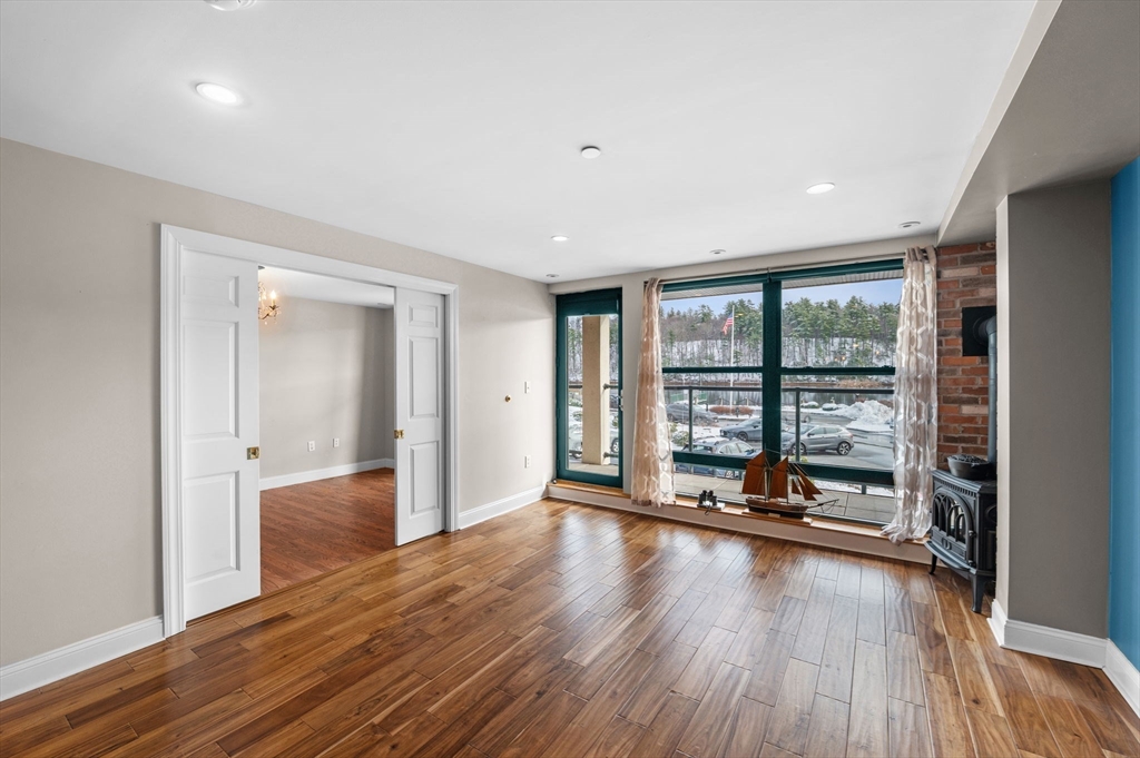 60 Merrimac Street, Unit 604 Amesbury, MA 01913 - Photo 5 of 42 a view of a room with wooden floor and floor to ceiling window