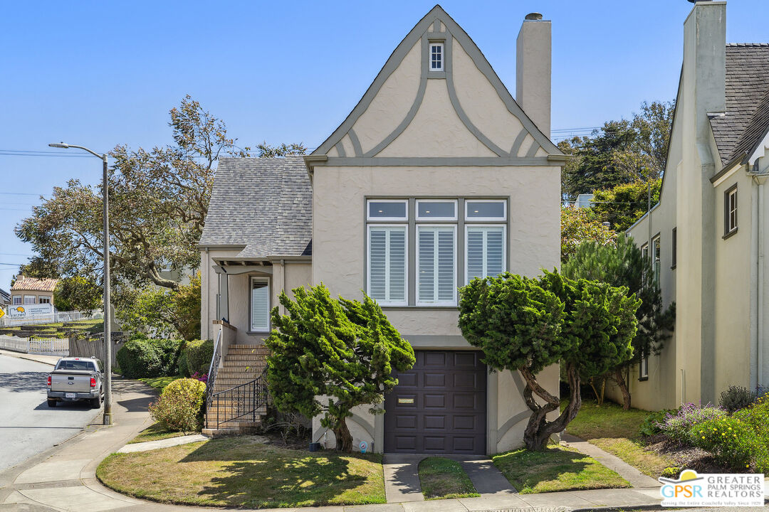 a front view of a house with garden