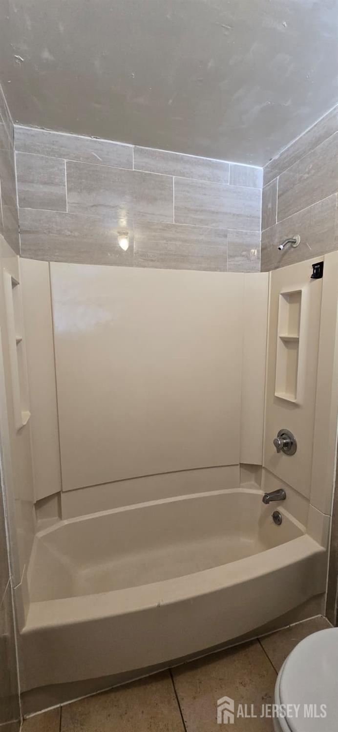 523 State Street Perth Amboy, NJ 08861 - Photo 12 of 22 a bathroom with a bathtub and a shower