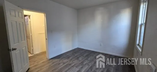 a view of an empty room and wooden floor