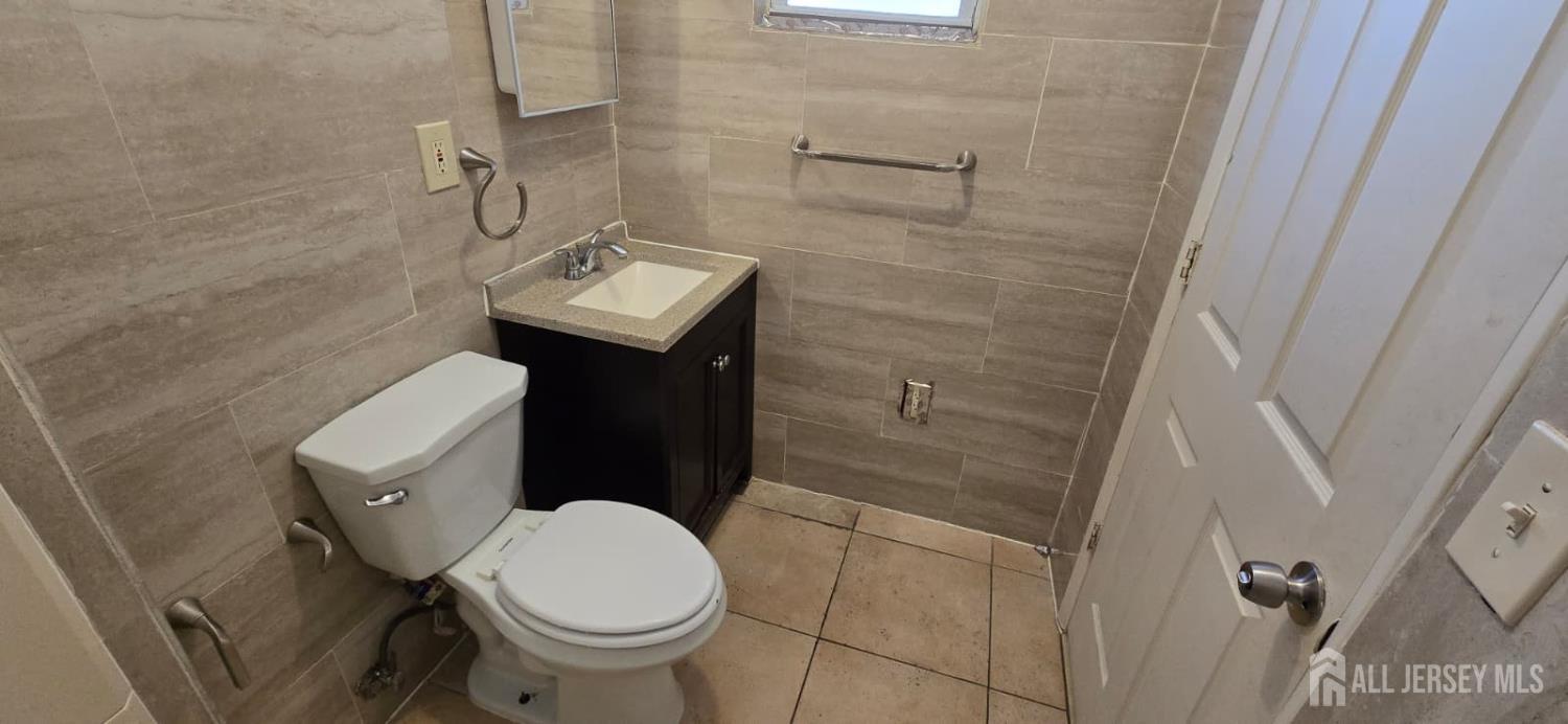 523 State Street Perth Amboy, NJ 08861 - Photo 15 of 22 a bathroom with a sink and a toilet