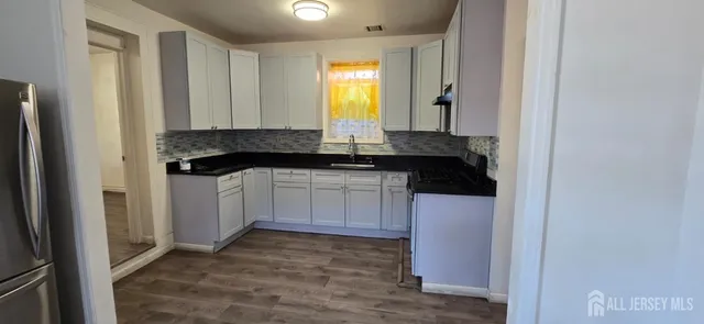 a kitchen with a sink and cabinets
