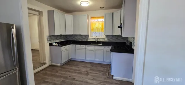a kitchen with a sink and cabinets