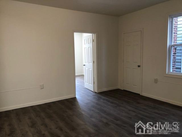 523 State Street Perth Amboy, NJ 08861 - Photo 5 of 22 an empty room with wooden floor and windows