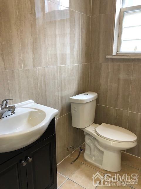 523 State Street Perth Amboy, NJ 08861 - Photo 10 of 22 a bathroom with a sink a toilet and a window