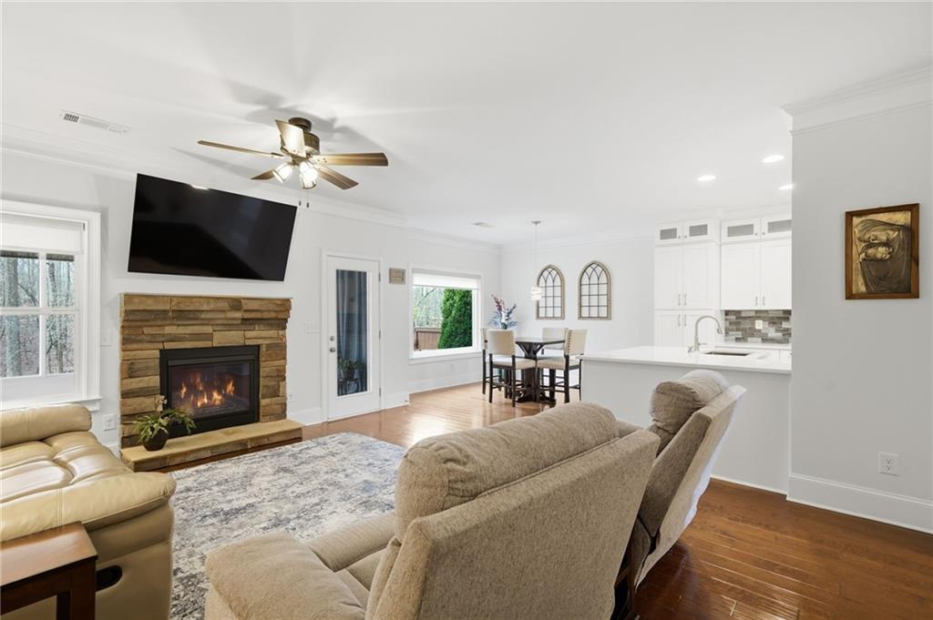 515 Sunset Street Canton, GA 30114 - Photo 11 of 64 a living room with furniture a fireplace and a flat screen tv