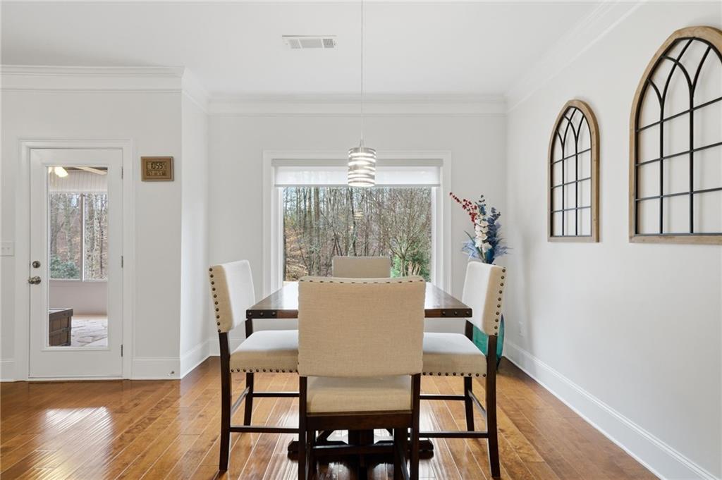 515 Sunset Street Canton, GA 30114 - Photo 14 of 64 a view of a dining room with furniture window and wooden floor