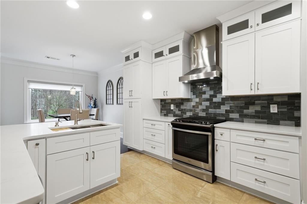515 Sunset Street Canton, GA 30114 - Photo 15 of 64 a kitchen with white cabinets stainless steel appliances and sink