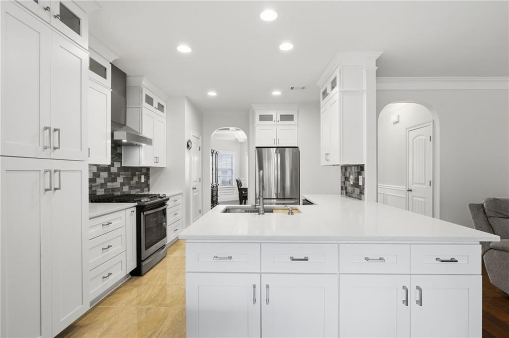 515 Sunset Street Canton, GA 30114 - Photo 17 of 64 a kitchen with kitchen island white cabinets and stainless steel appliances